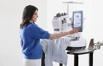 Image of a person operating a Brother Multi-needle embroidery machine