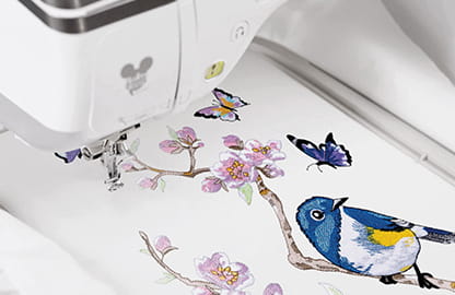 Image of a built-in embroidery design in the Brother Innov-is XJ2 Sewing, Quilting and Embroidery Machine depicting a bird and Butterflies and a cherry blossom branch