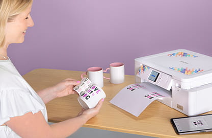 Image of a lady applying a sublimation print from the Brother Sublimation SP1 printer to a mug