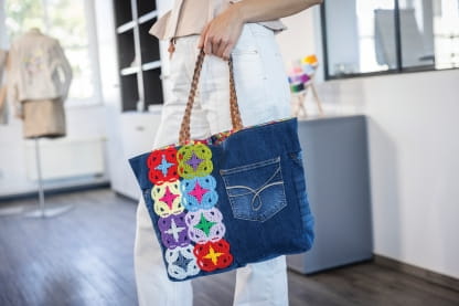 Image of a person carying a bag with Yarn Couching motifs