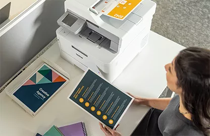 woman and print-out next to printer