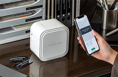 hand holding labelling app next to p-touch