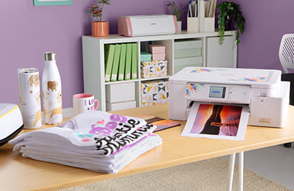 Image of T-Shirts that have been printed using the Brother Sublimation SP1 printer and an image being printed on the Sublimation SP1 printer