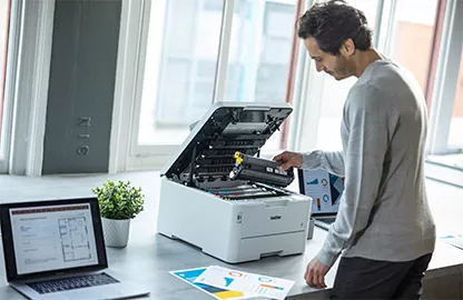 man next to laser printer