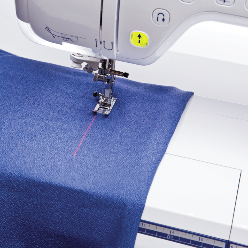 Brother BQ3100 Sew Straight Laser Vision Guide projected onto blue fabric