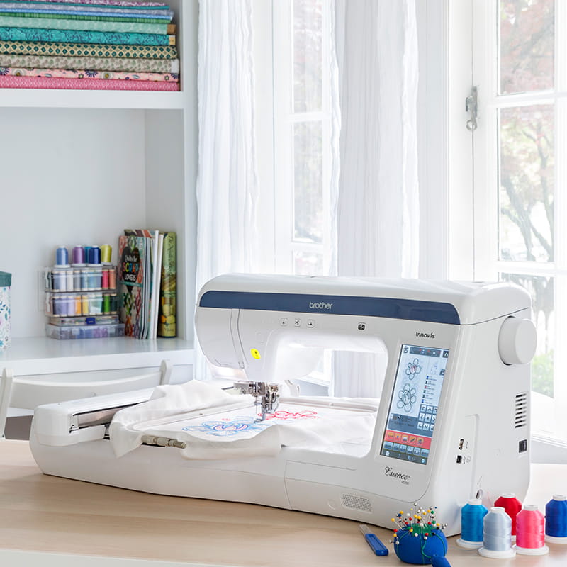 embroidery machine ve2300 on a desk with thread