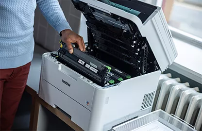 man loading toner into printer
