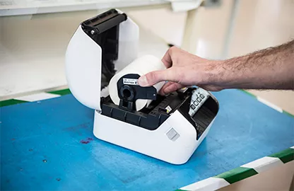 hand loading DK label roll into label printer