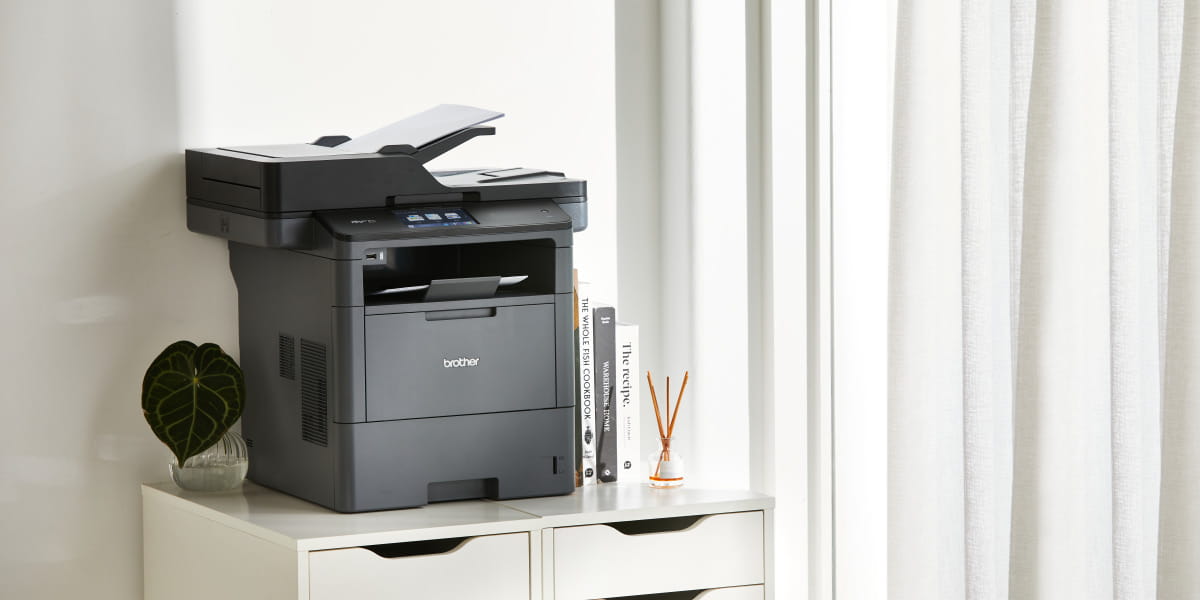 A Brother monochrome laser multi-function printer in a small office 