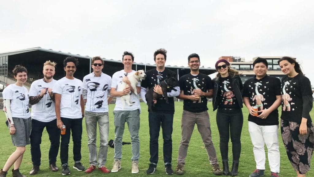 A number of young adults standing in a field