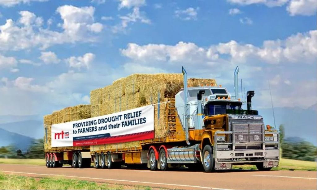 Truck with signage driving on road