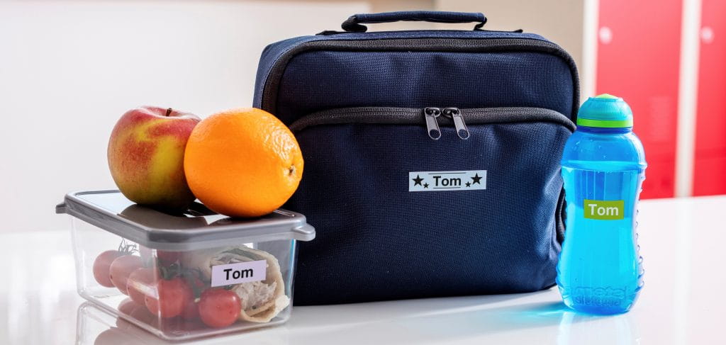 A child's lunchbox and water bottle with labels on them.