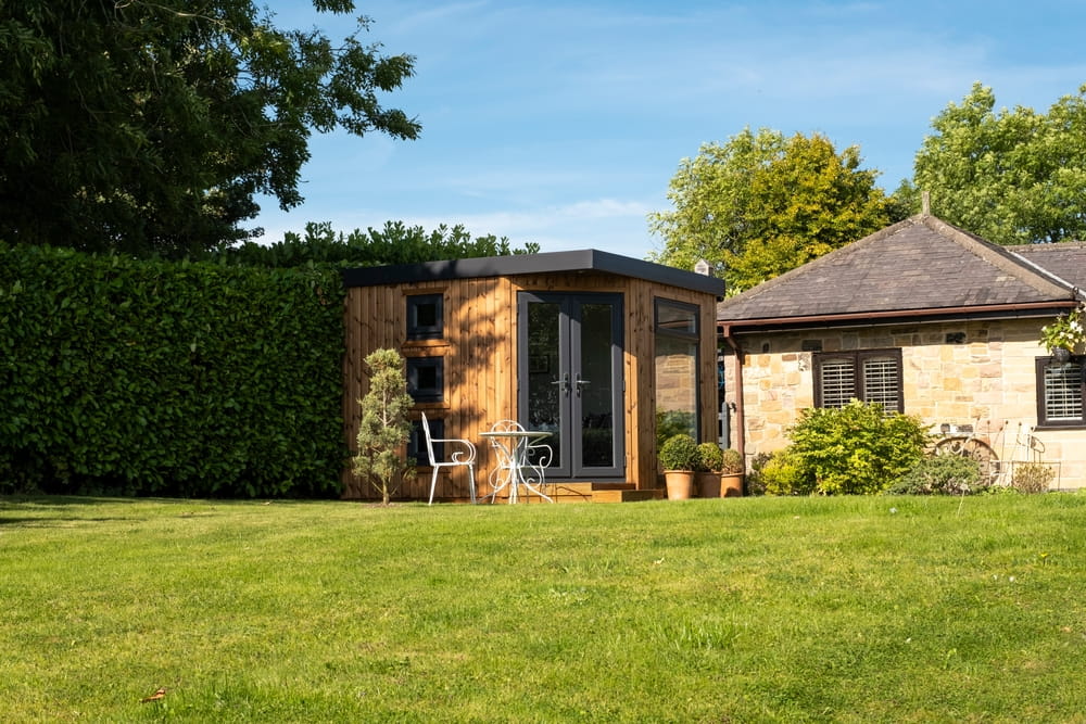 A backyard office pod next to the main house. 