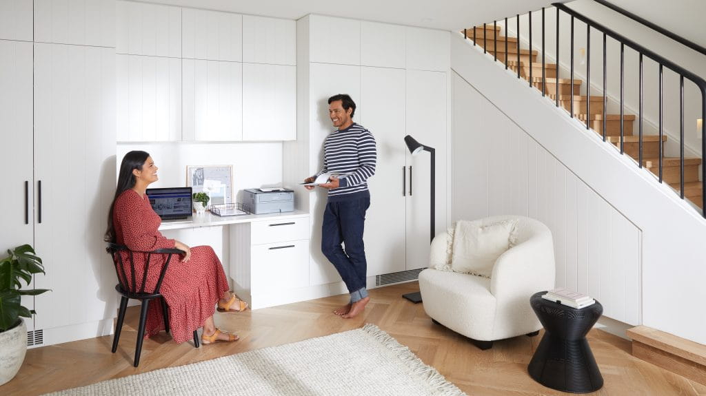 A man and a woman in their study nook in the living room.