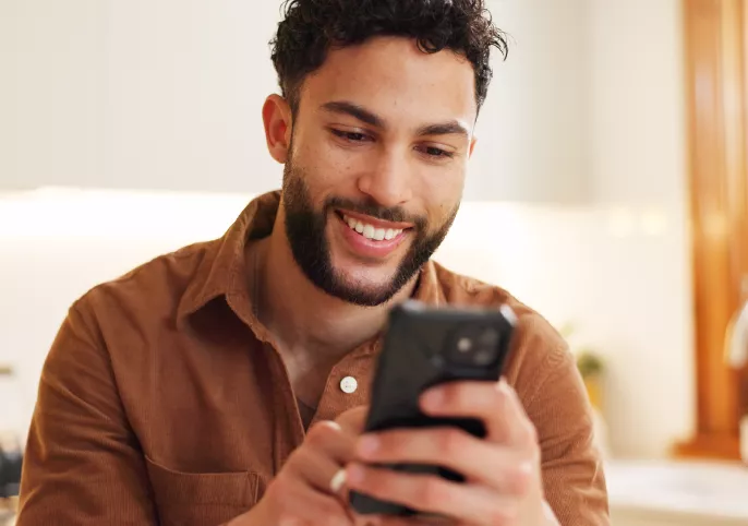 Man smiling at his phone
