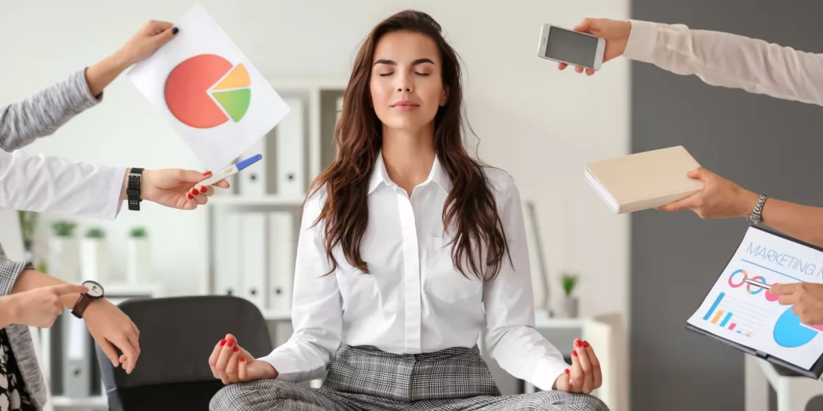 Lady meditating with multiple arms handing her office and work items