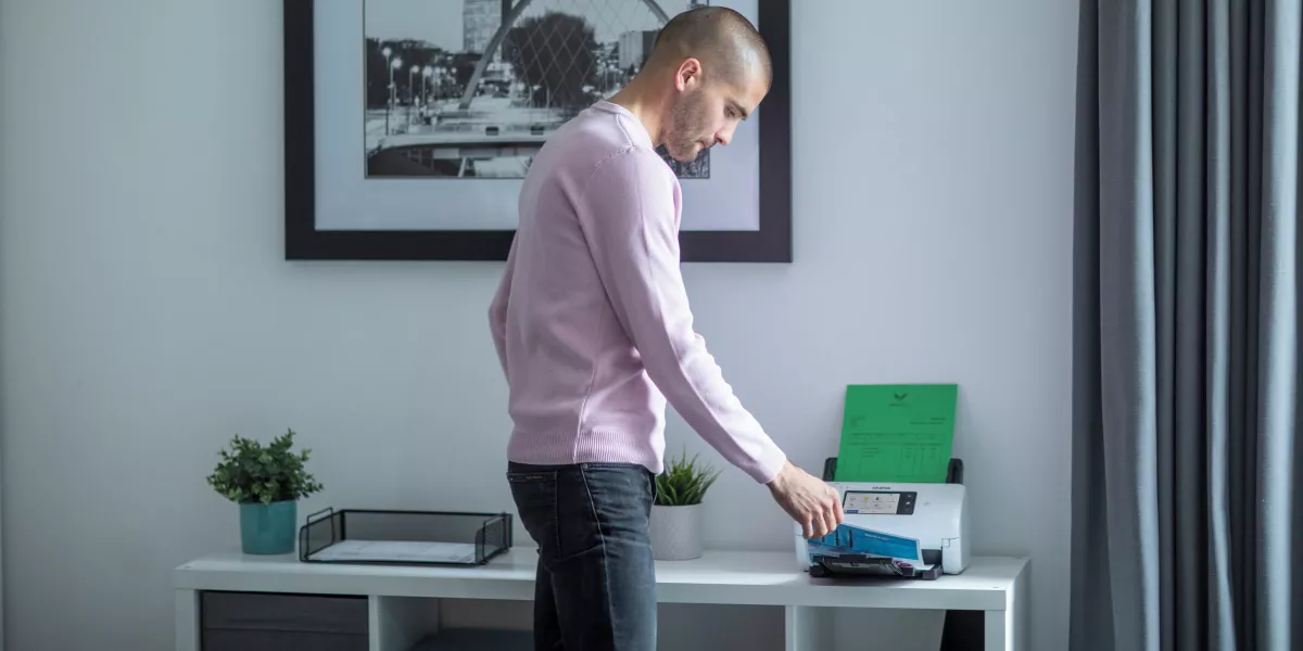 Man scanning documents using the Brother ADS-4700W