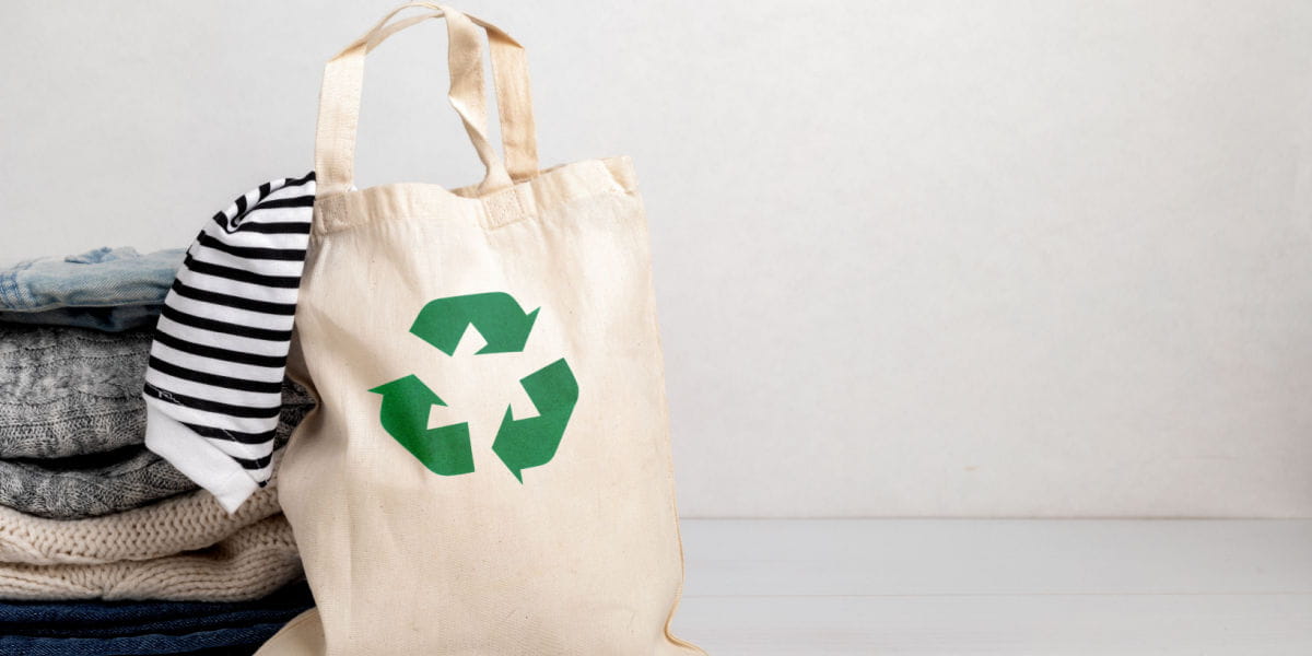 A shopping bag with an eco-friendly recyclable logo on it