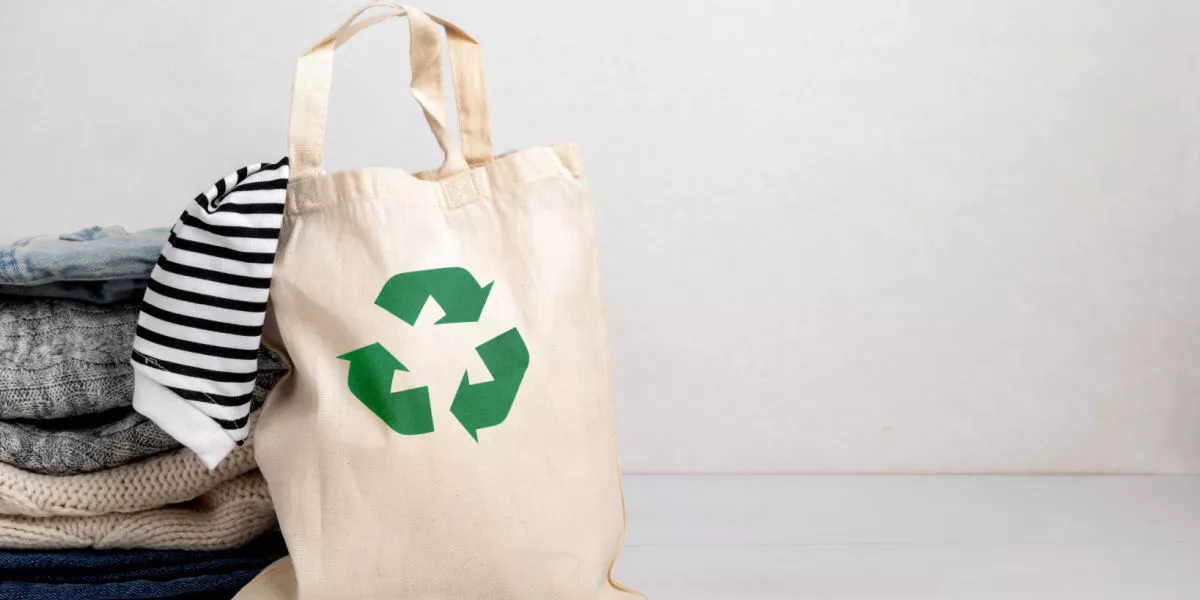 A shopping bag with a eco-friendly recyclable logo on it