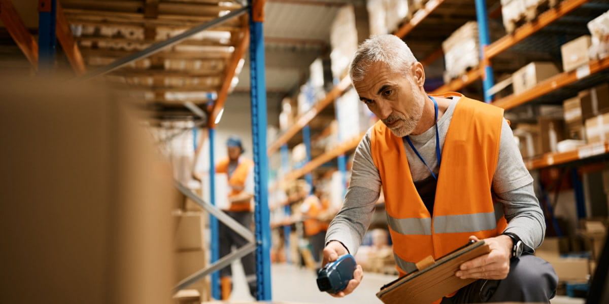 A supply chain worker scanning stock in a warehouse