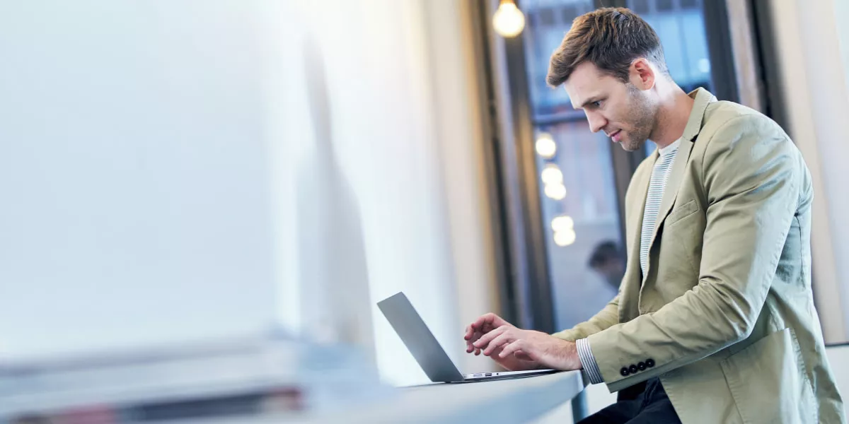 An ecommerce business owner on a laptop in a professional environment