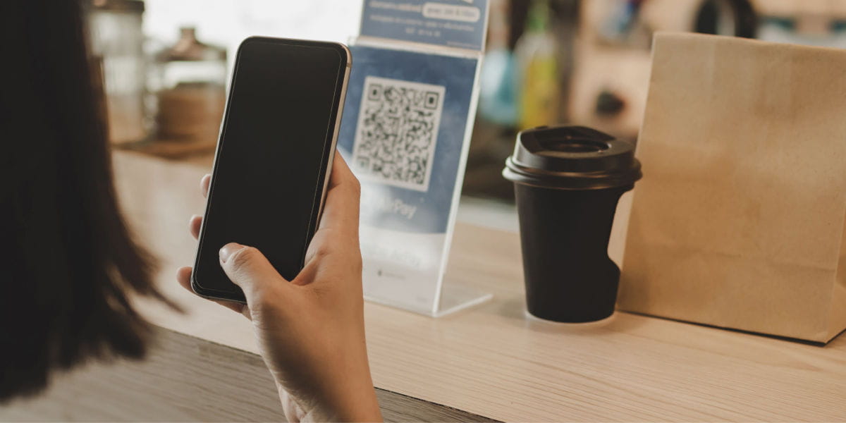 A lady scanning a QR code with her smartphone.