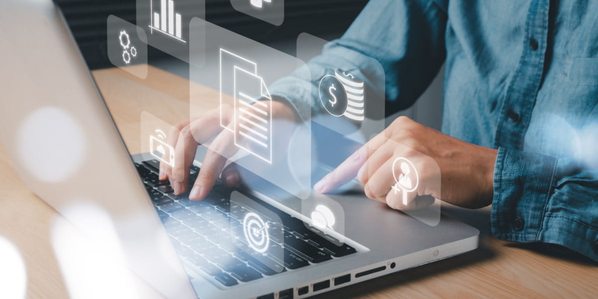 Person typing on laptop with visual depiction of HR tech processes