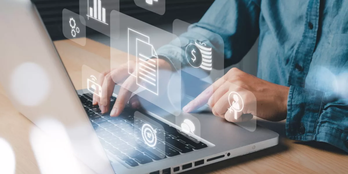 Person typing on laptop with visual depiction of HR tech processes