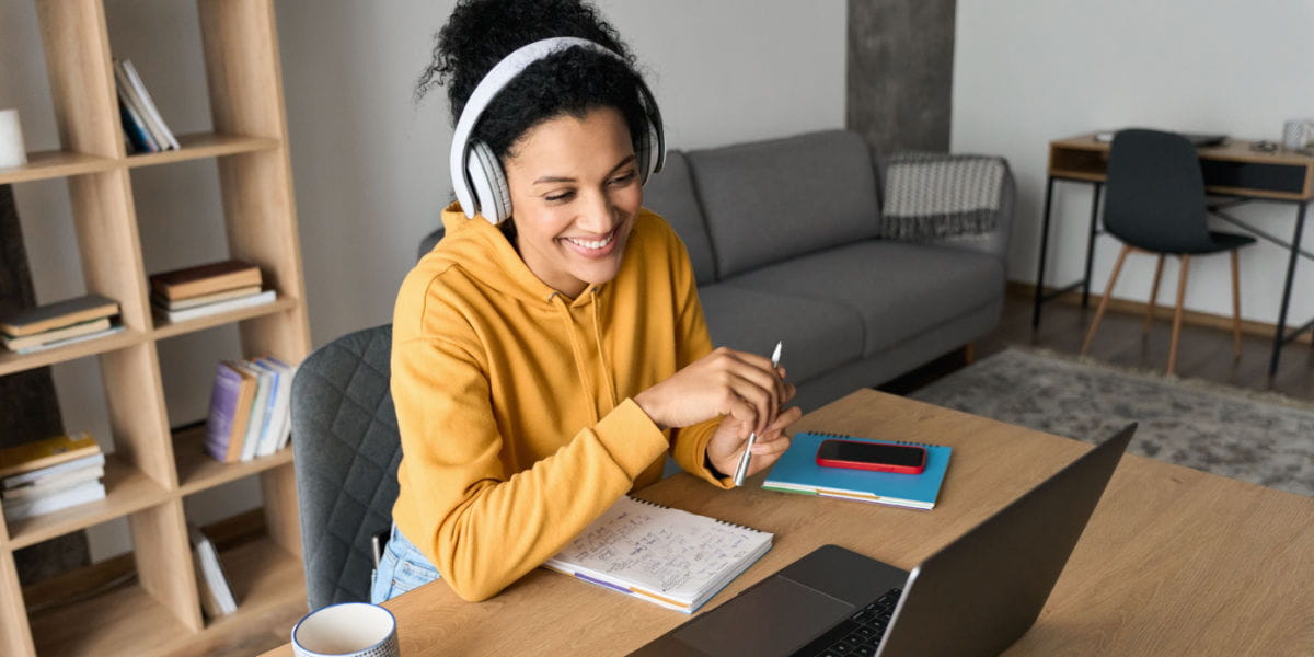 Lady with notepad on laptop during a virtual job interview