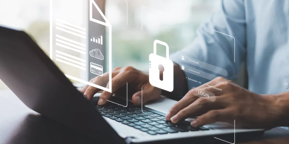 A man on a laptop with a padlock depicting digital security