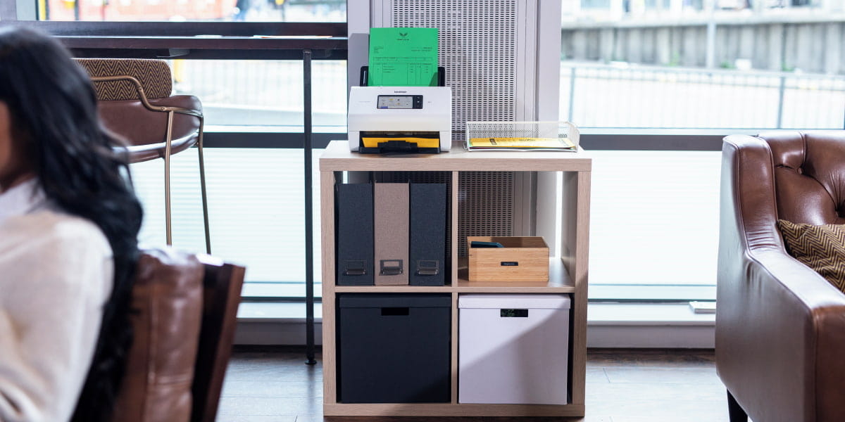 A Brother document scanner ADS-4900W in an office setting