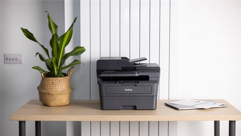 A Brother MFC-L2880DWXL monochrome multi-function printer in a small business setting
