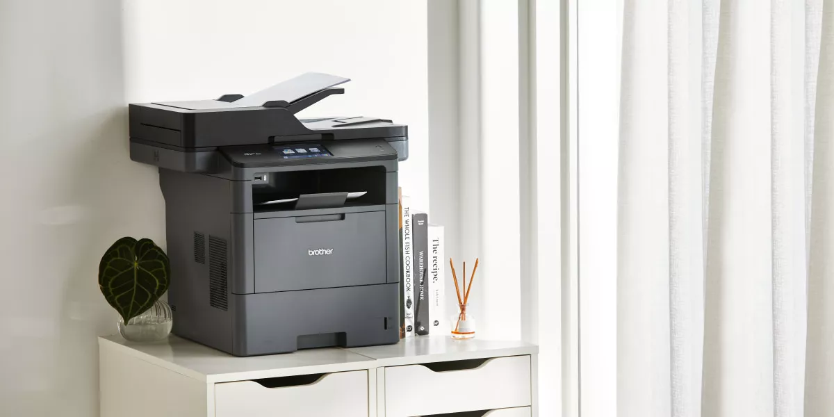 A Brother monochrome laser multi-function printer in a small office