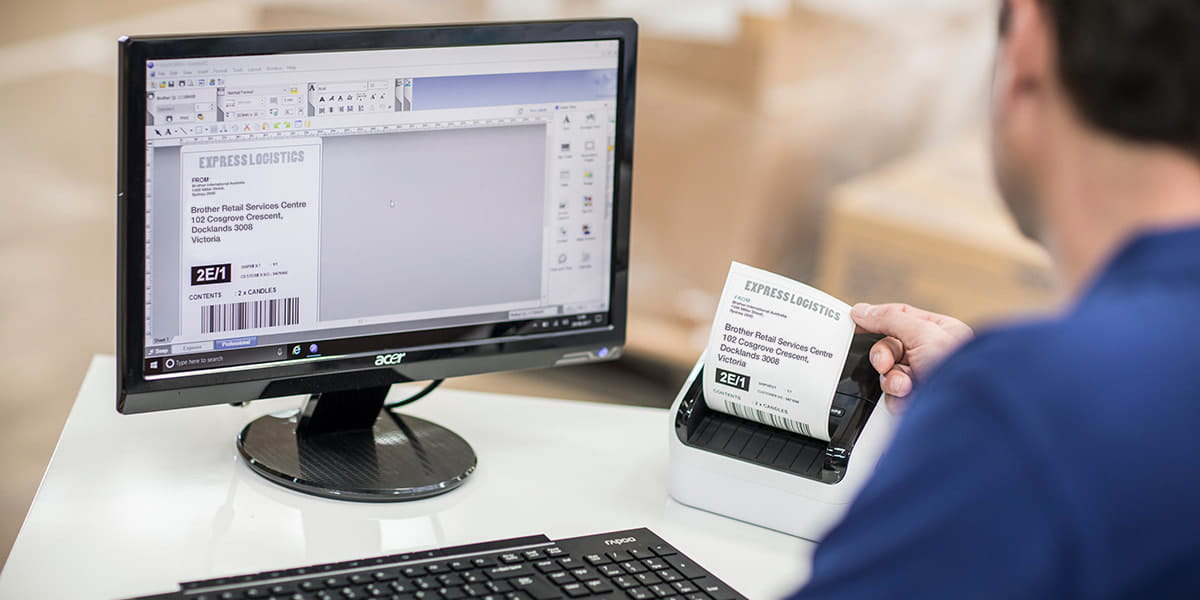 A Brother QL-1110NWB label printer with a person printing shipping labels from a computer