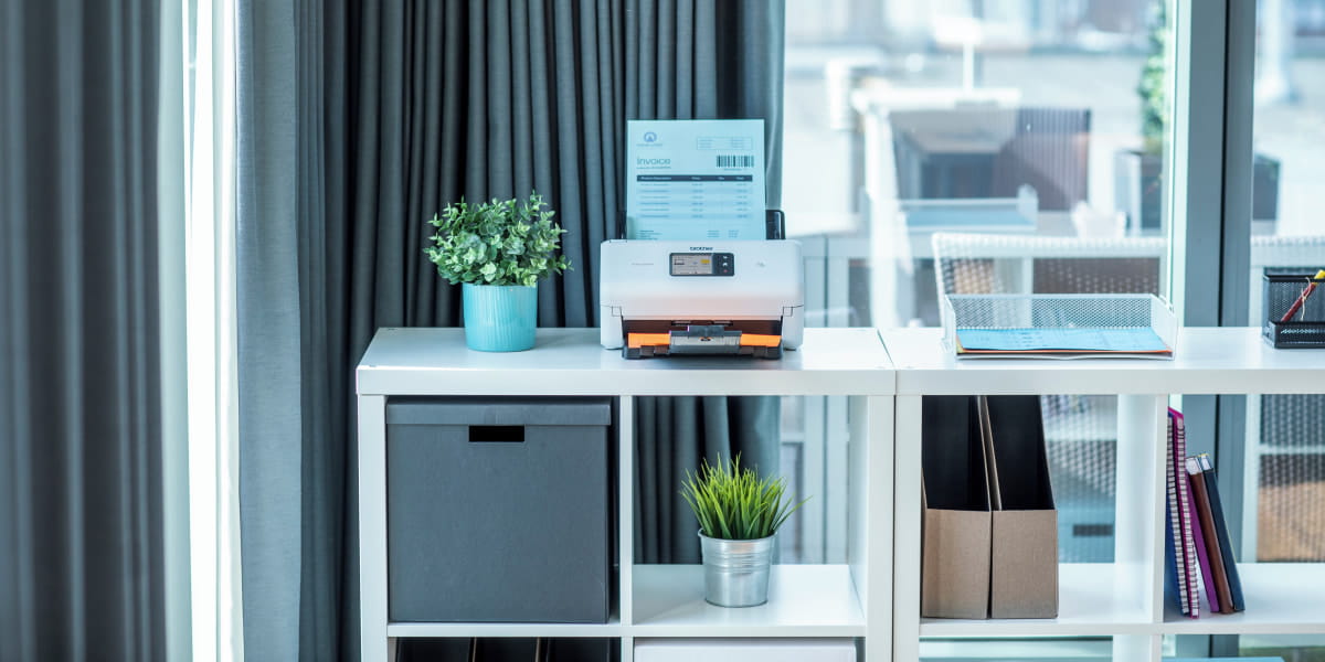 A Brother document scanner in a home office