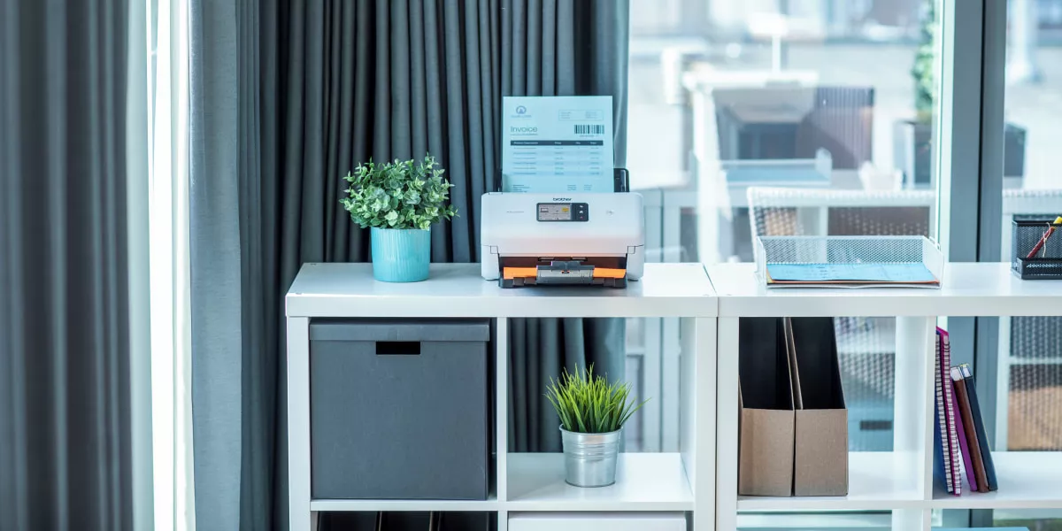 A Brother document scanner in a home office
