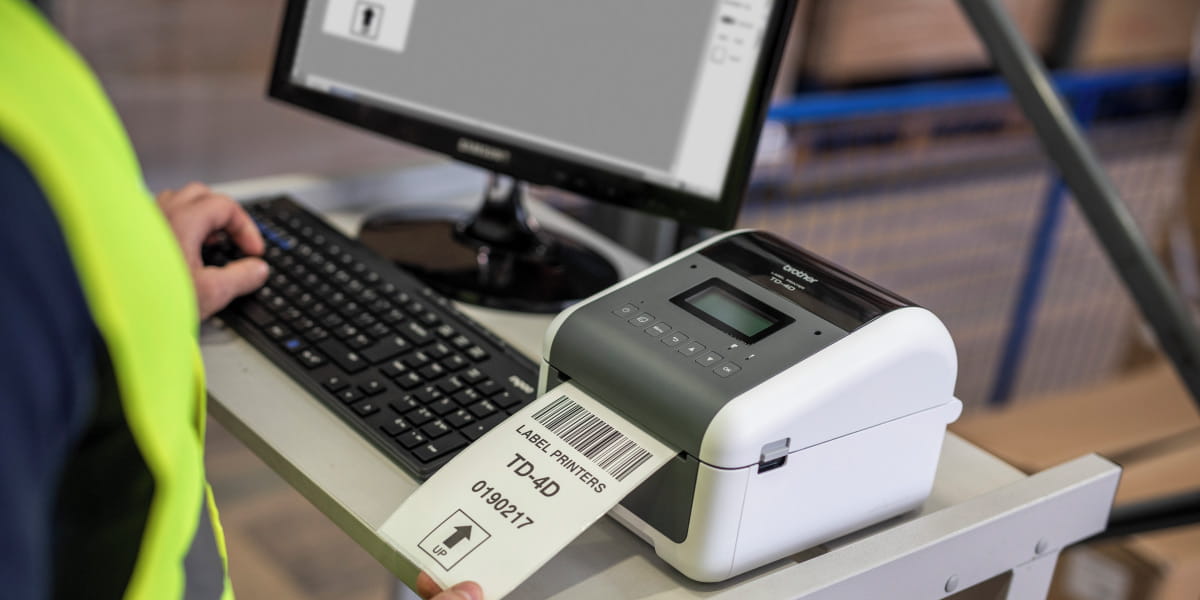 A Brother TD-4550DNWB thermal label printer printing product labels