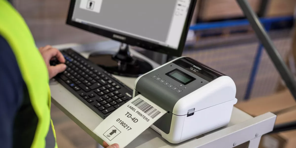 A Brother TD-4550DNWB thermal label printer printing product labels