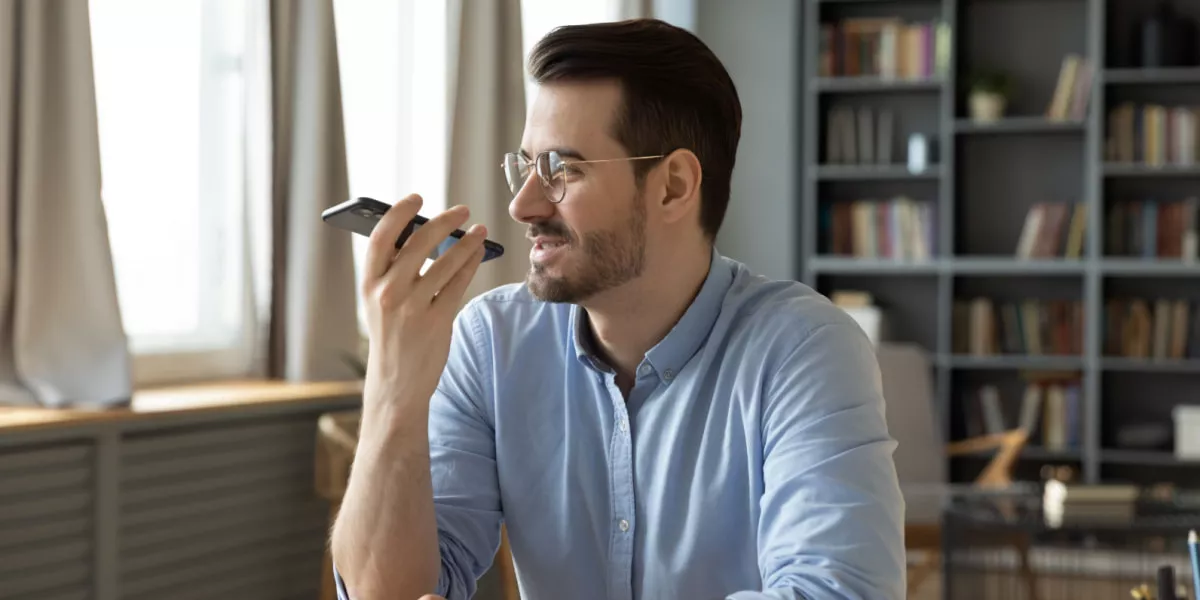 A man using voice command on his smartphone while shopping online