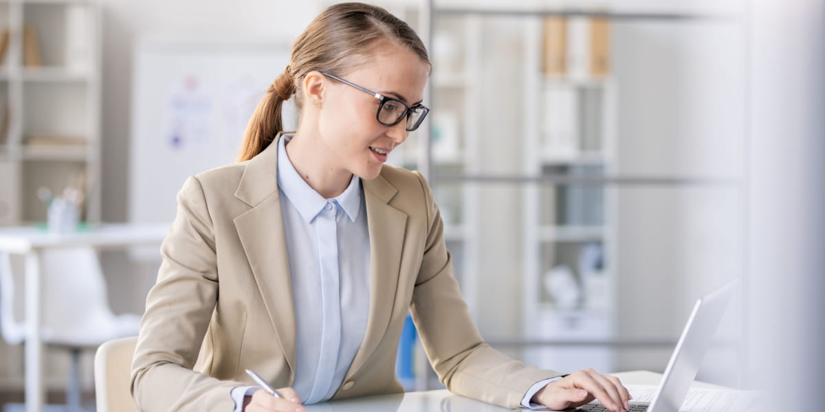 Female small business owner on a laptop in a home office environment