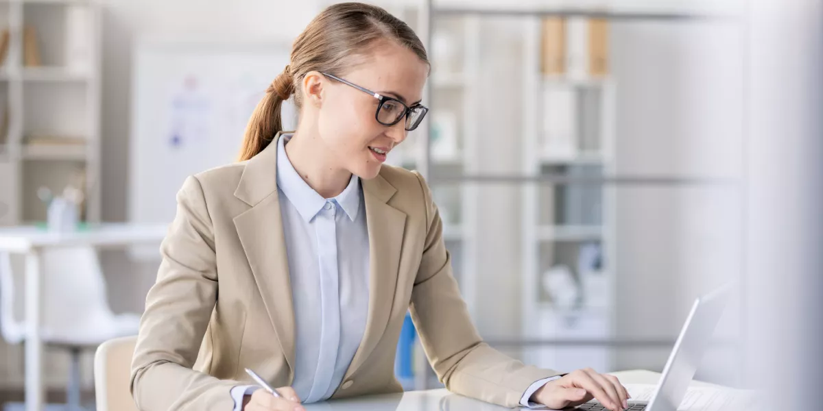 Female small business owner on a laptop in a home office environment