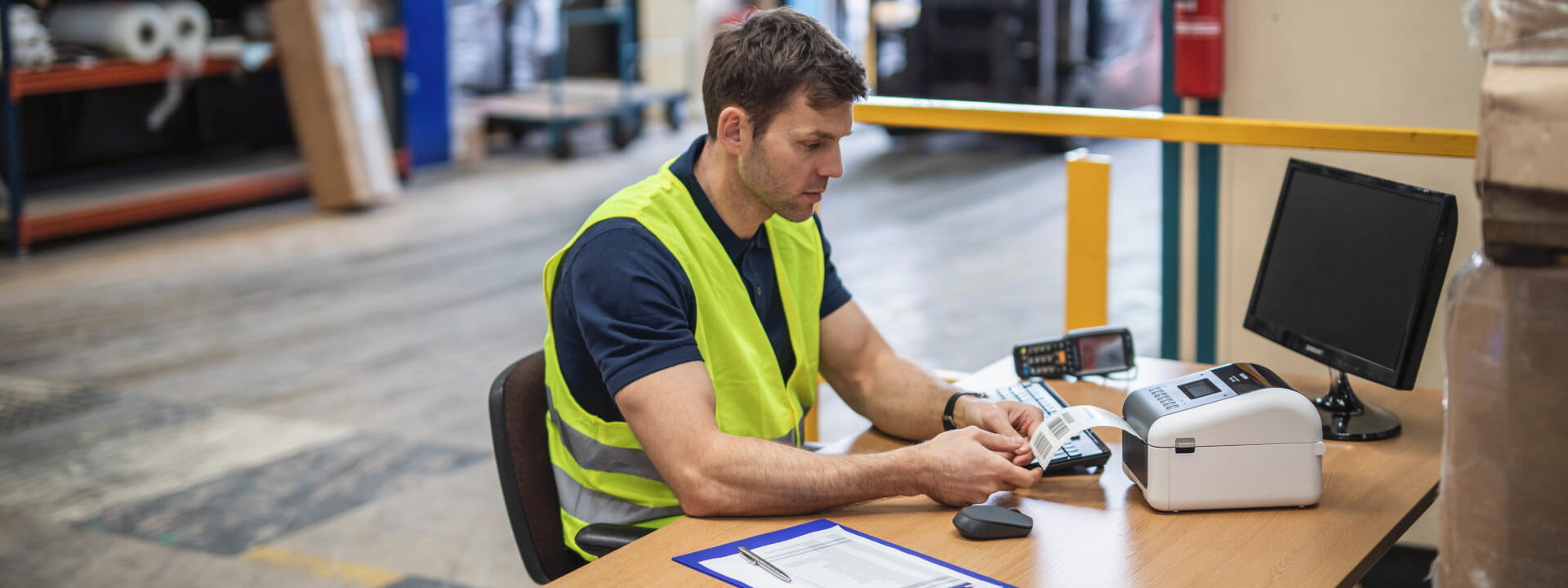 A warehouse worker printing labels on a thermal label printer