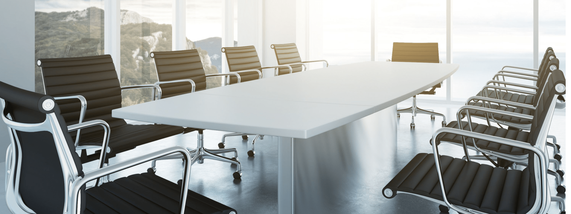 An empty office boardroom with a large desk and multiple chairs.