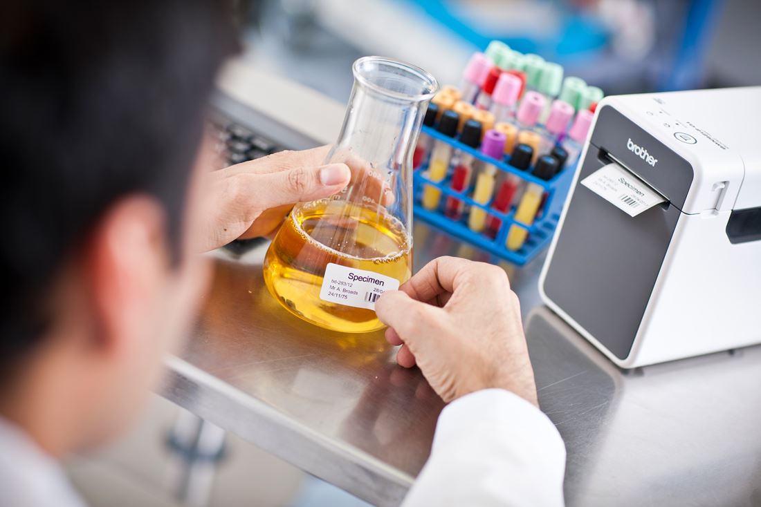 A lab technician labelling samples in a laboratory setting