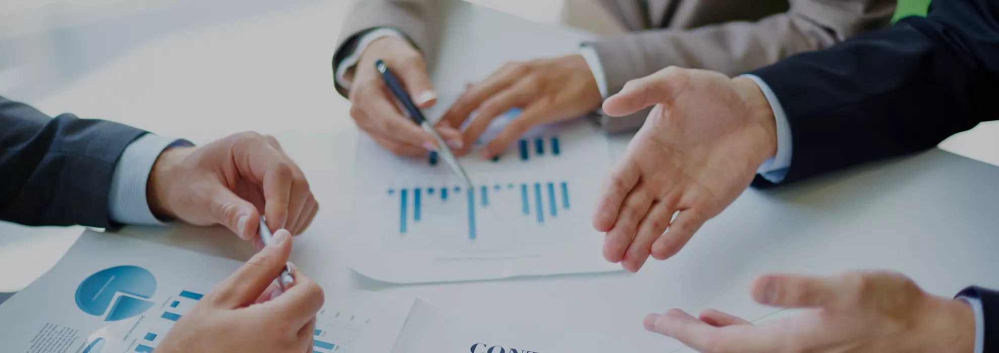 Image of business partners hands over business objects