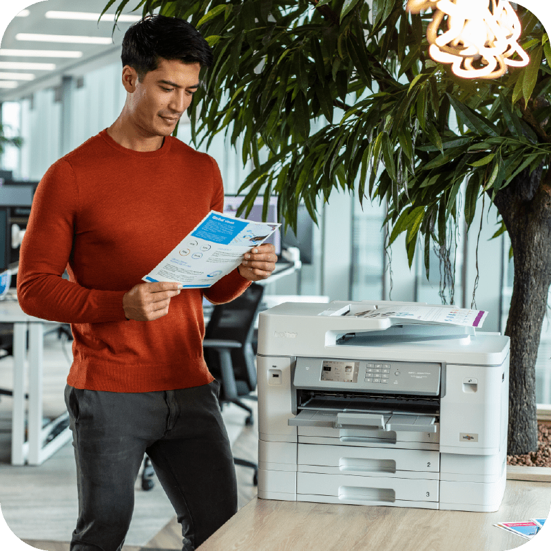 man looking at a printed document