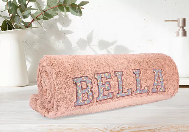 Image of a towel with applique fabric letters
