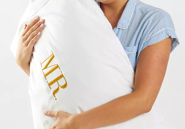 image of a person holding a Embroidered pillow