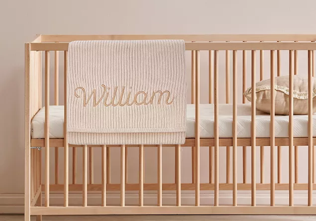 image of an embroidered baby blanket using creative lettering