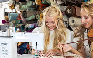 Image of two girls sewing on the Brother PQ1600S high speed straight stitch sewing machine
